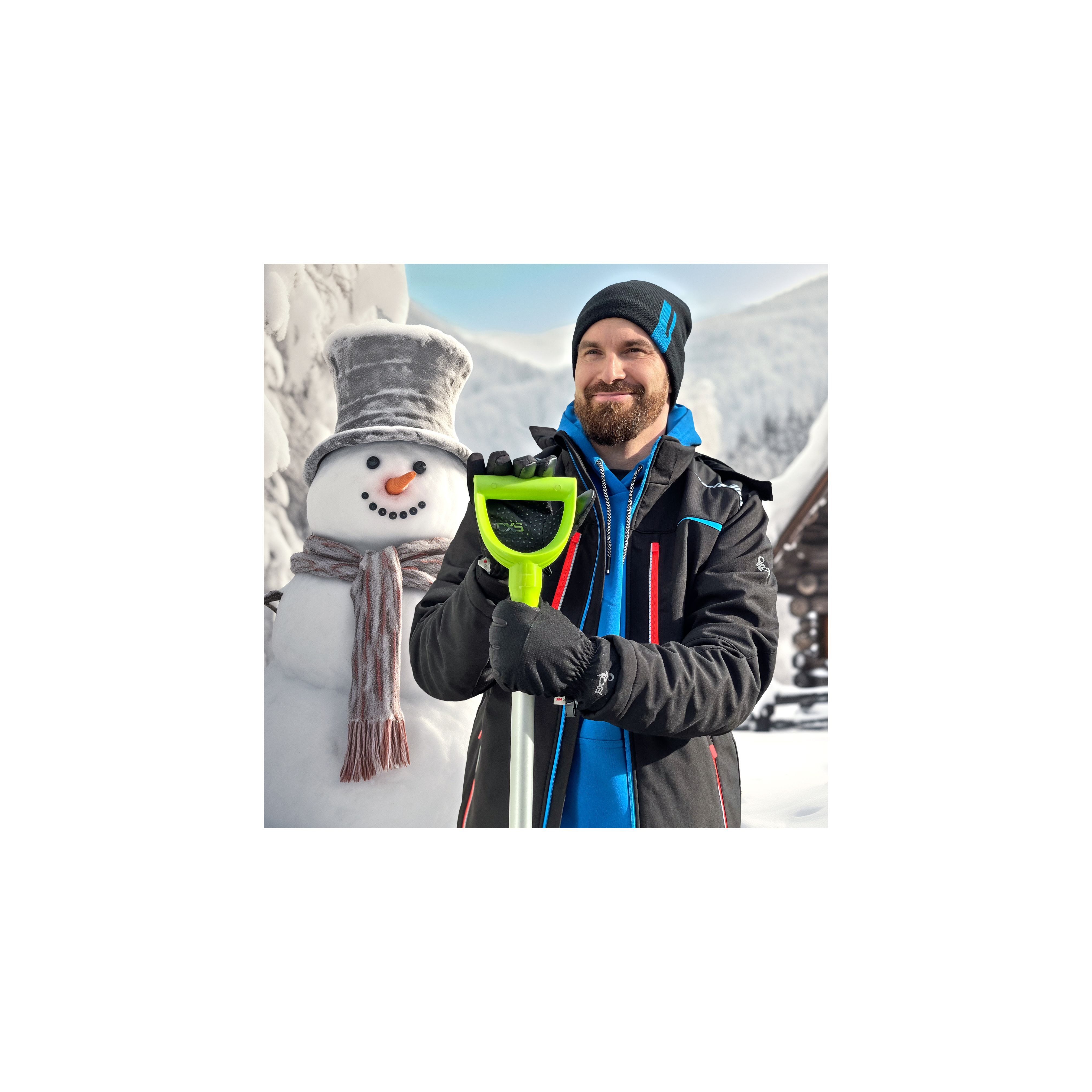 Person holding a green snow shovel next to a snowman in a snowy landscape